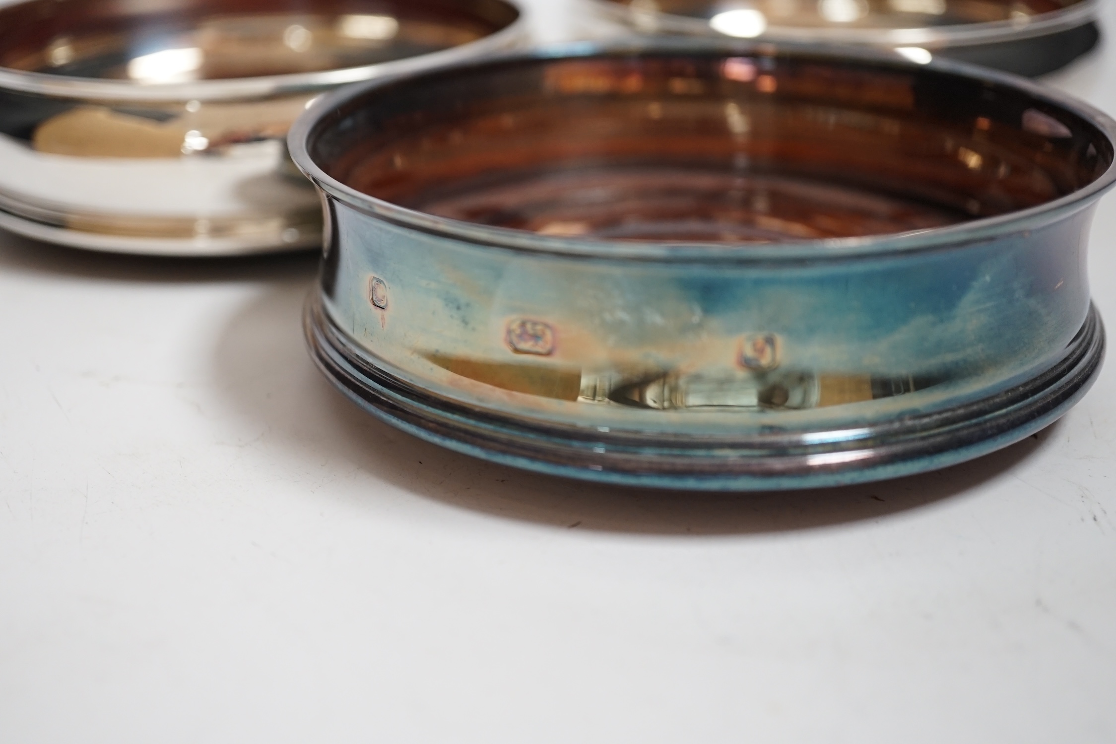 Six modern silver mounted wine coasters, including pierced pair, London, 2009, diameter 12.5cm, three boxed in total.